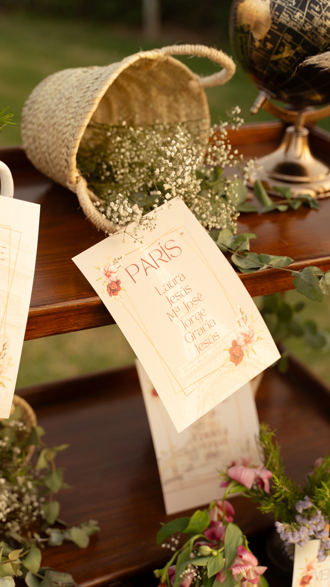 Detalle del seating: una tarjeta con el nombre París junto a una cesta de flores