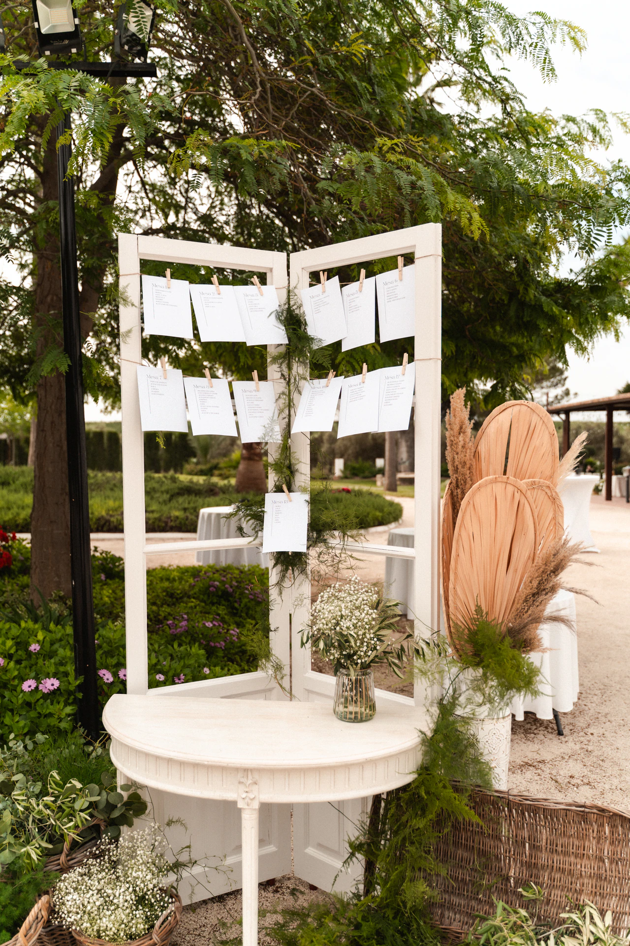 El seating colgado de una estructura de puertas blancas en el jardín